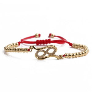 Adjustable red rope bracelet with gold infinity charm and sparkling cubic zirconia pavé