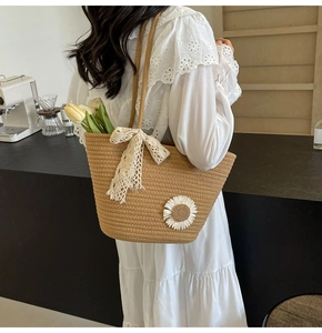 Detail of hand-woven tote bag with lace bow and daisy floral embroidery on model