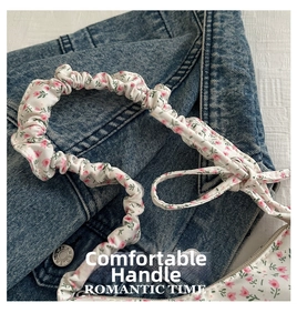 Detailed macro of floral fabric strap with pink flowers and romantic ribbon tie