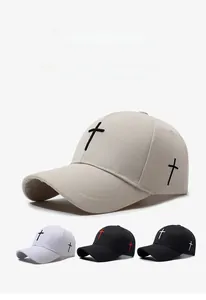 Detail of cross embroidery on cotton baseball caps in khaki, white and black colors