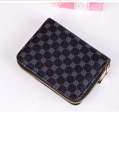 Detail of black multilayer card wallet with grey clover pattern and gold zipper hardware