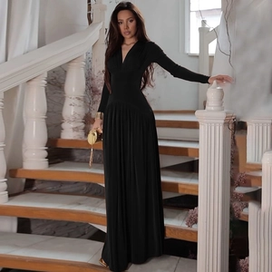 Detail view of elegant black long-sleeve pleated maxi dress with a flattering V-neckline