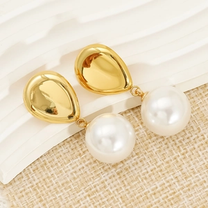Elegant gold drop earrings with irregular metallic studs and large white round pearls