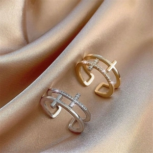 Double-layered cross rings in gold and silver finish with sparkling zircons on satin