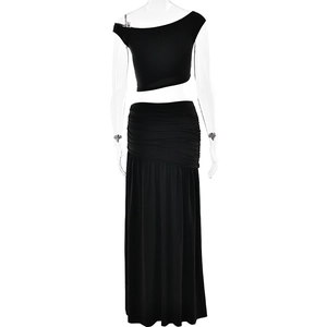 Close-up of black two-piece set with off-shoulder crop top and side pleated maxi skirt