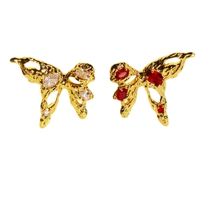 Golden liquid metal butterfly stud earrings with red and white zircons on a white background