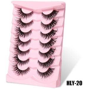 Close-up of 7 pairs of thick DIY false eyelashes with clear bands on a pink tray