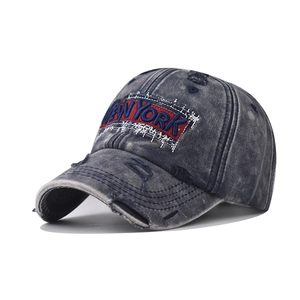 Close-up of vintage washed cotton baseball cap with New York embroidery and distressed details