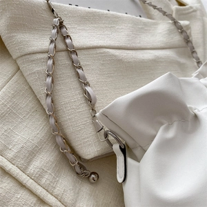 White ruched cloud crossbody bag with silver metal chain strap and spherical charm