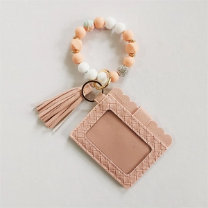 Pink faux leather card holder detail with silicone beads, wooden beads and stylish tassel