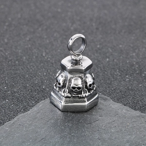 Macro shot of stainless steel skull bell pendant with vintage punk engraved details
