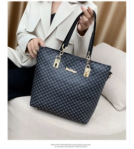 Close-up of stylish tote bag featuring geometric patterns and premium gold hardware details