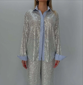 Detail of sequin blazer and trousers set featuring blue and white striped fabric cuffs