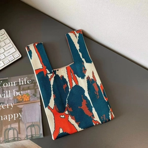 Detail of colorful knit tote bag featuring abstract art pattern and soft woven texture