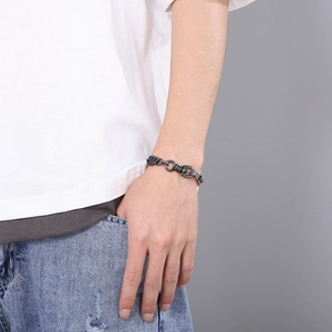 Men's retro titanium steel chain bracelet with dark gray U-shaped buckle on male wrist