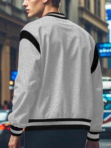 Close-up of the grey cotton knitted baseball jacket with contrasting black raglan sleeves