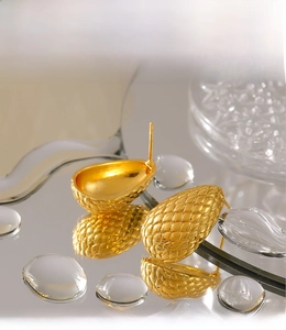 Detail of PVD electroplated 18k gold water drop earrings with woven mesh texture on mirror