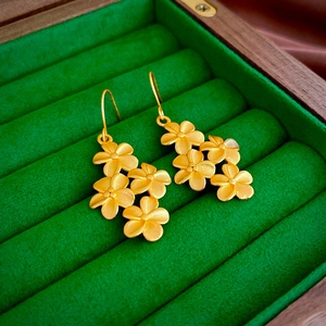 Minimalist gold flower drop earrings with matte finish in a velvet jewelry box