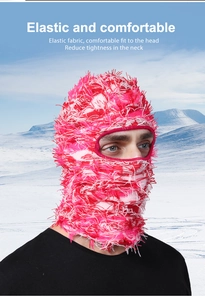 Close-up of pink knit ski mask with plush fringe texture and eye openings for winter