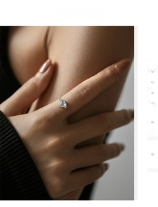 Detail of a S925 silver heart ring with moonstone and twisted band on a hand
