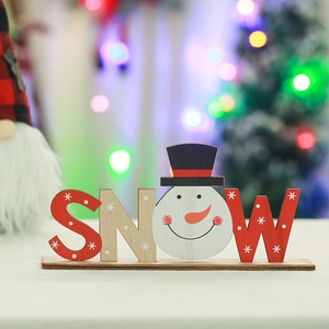 Close-up of wooden SNOW letter ornament with snowman figure on a rustic base