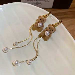 Velvet flocking bear earrings with long gold tassels and pearls for a retro chic look