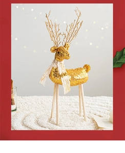 Detail of Christmas reindeer decoration with gold sequins, white scarf, and wooden legs