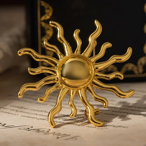 Detailed view of sunburst vintage gold-plated brooch on a classic letterhead paper