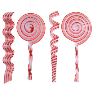 Close-up of red and white striped acrylic Christmas candy cane ornaments on white background