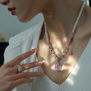 Rainbow gemstone pearl necklace with silver chain and pink pendant on model