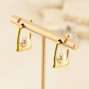 French retro square gold earrings with white pearl inlay on a T-shaped display stand
