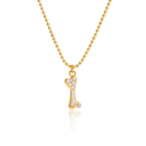 Close-up of a 18K gold-plated dog bone pendant set with sparkling rhinestones