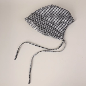 Detail of baby gingham bonnet with soft cotton fabric and adjustable chin straps