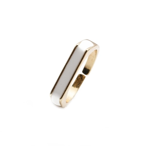 Detail of adjustable gold-plated ring featuring geometric white enamel inlay