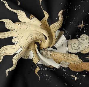 Detail of celestial moon and sun wall tapestry showing soft woven fabric and print