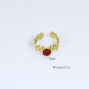 Detailed view of gold plated ring with 7mm red gemstone and 2.1g weight specs
