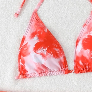 Detail of red floral halter bikini top with texture and white tie strings for beachwear