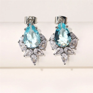 Macro shot of light blue pear-shaped zircon earrings with marquise-cut accents