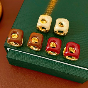 Detailed view of vintage French square enamel earrings in white, brown, and red colors