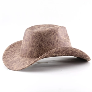 Close-up of vintage brown western cowboy hat with distressed crackle texture and wide brim