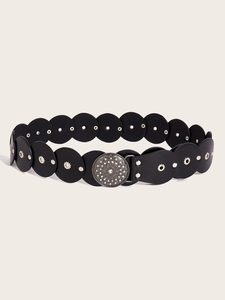 Macro detail of bohemian black leather belt with silver rivets and vintage buckle
