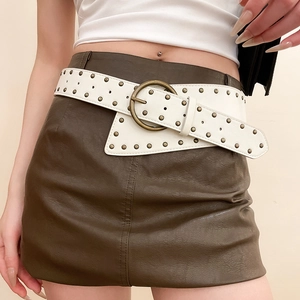 Close-up of a white leather belt with vintage bronze studs and a round metal buckle