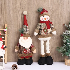 Standing Santa Claus and Snowman plush figurines with festive wooden background decor