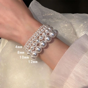 French retro pearl elastic bracelets in four sizes 4mm 8mm 10mm and 12mm on lace background