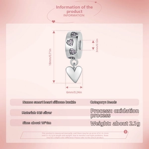 Macro detail of S925 sterling silver heart bead with pink gemstone and size parameters