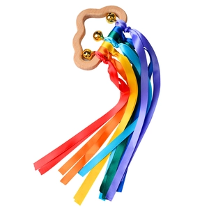 Close-up of cloud-shaped wooden baby teether with rainbow ribbons and small bells