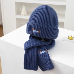 Detail of dachshund embroidery on blue ribbed knit hat and scarf set for kids