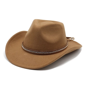 Detail of light brown cowboy hat featuring a double-row rhinestone and metal stud band