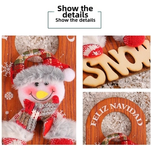 Detail of wooden Christmas door hanger featuring a 3D plush snowman and FELIZ NAVIDAD text