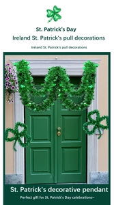 Green St. Patrick's Day tinsel garland with clover ornaments on a wooden door decor